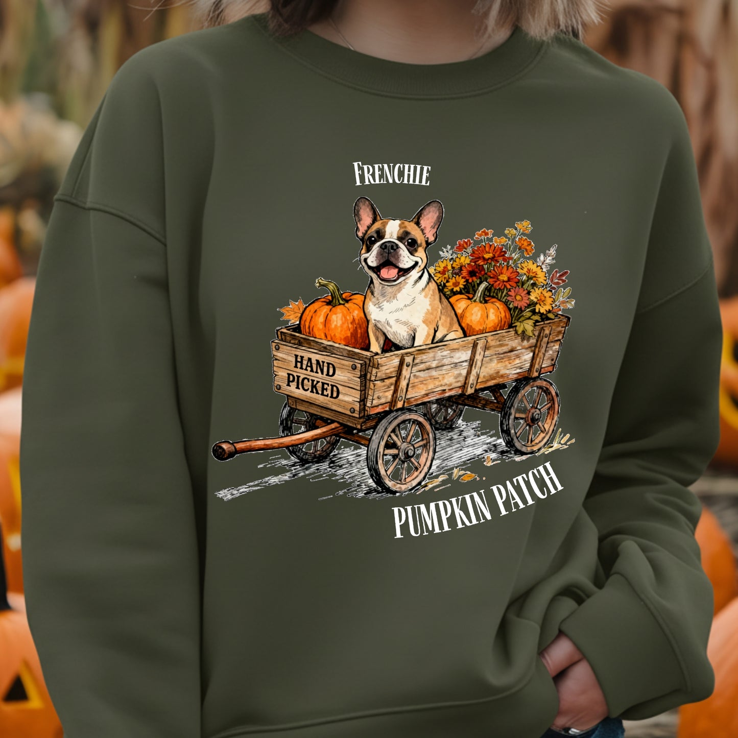 Green sweatshirt with a dog and pumpkin patch design, worn by a person.