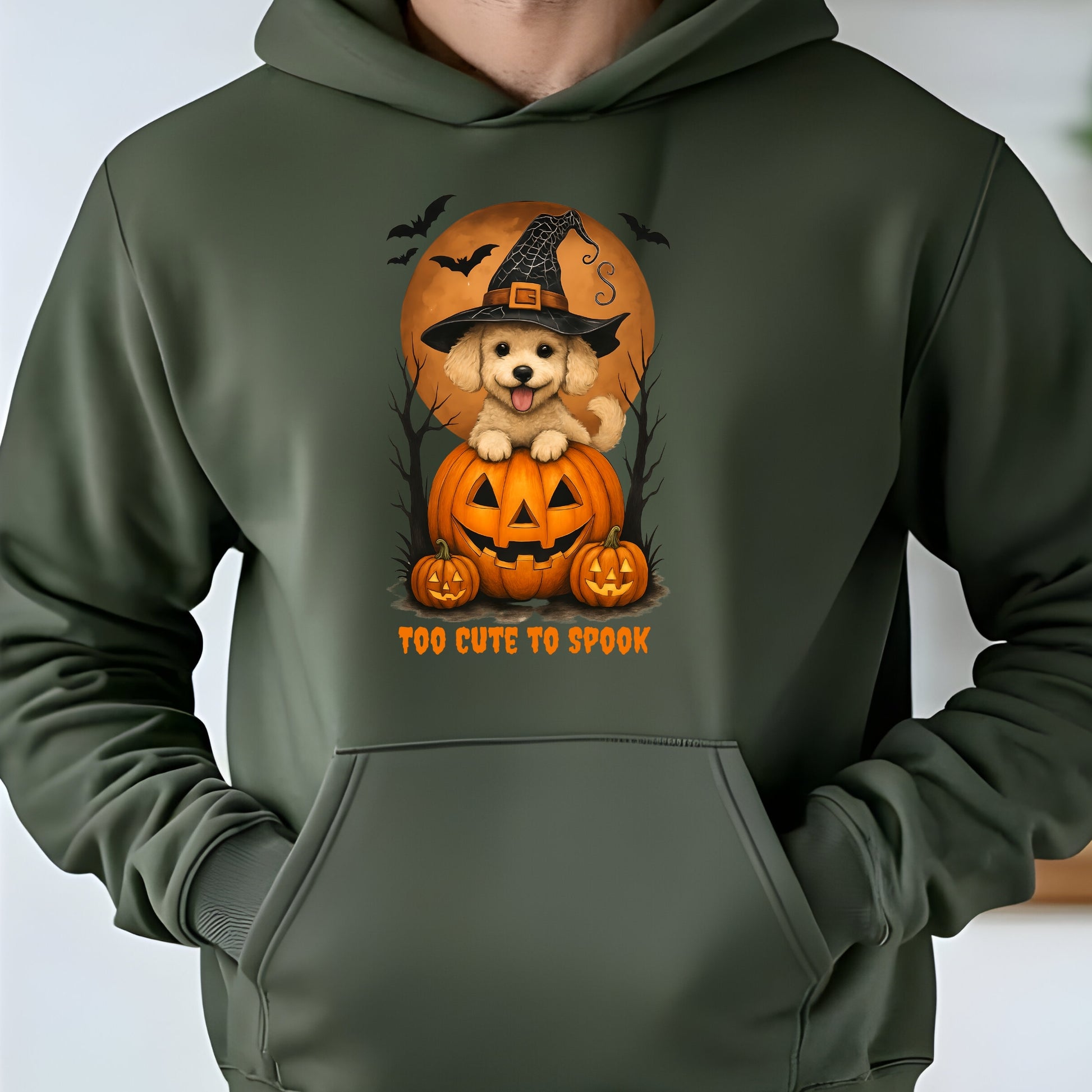 Green hoodie with a Halloween-themed design featuring a dog in a witch hat and pumpkins.