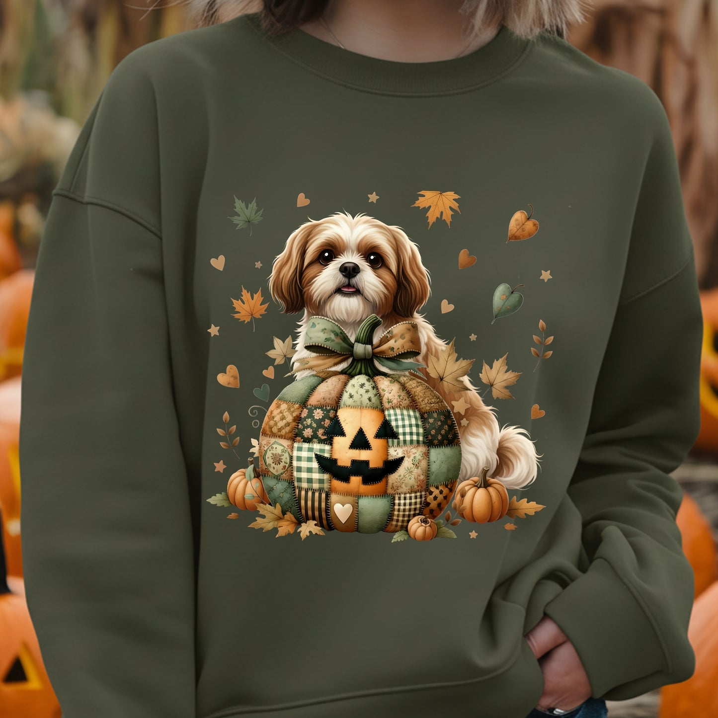 Green sweatshirt with a dog and autumn-themed design, worn by a person.