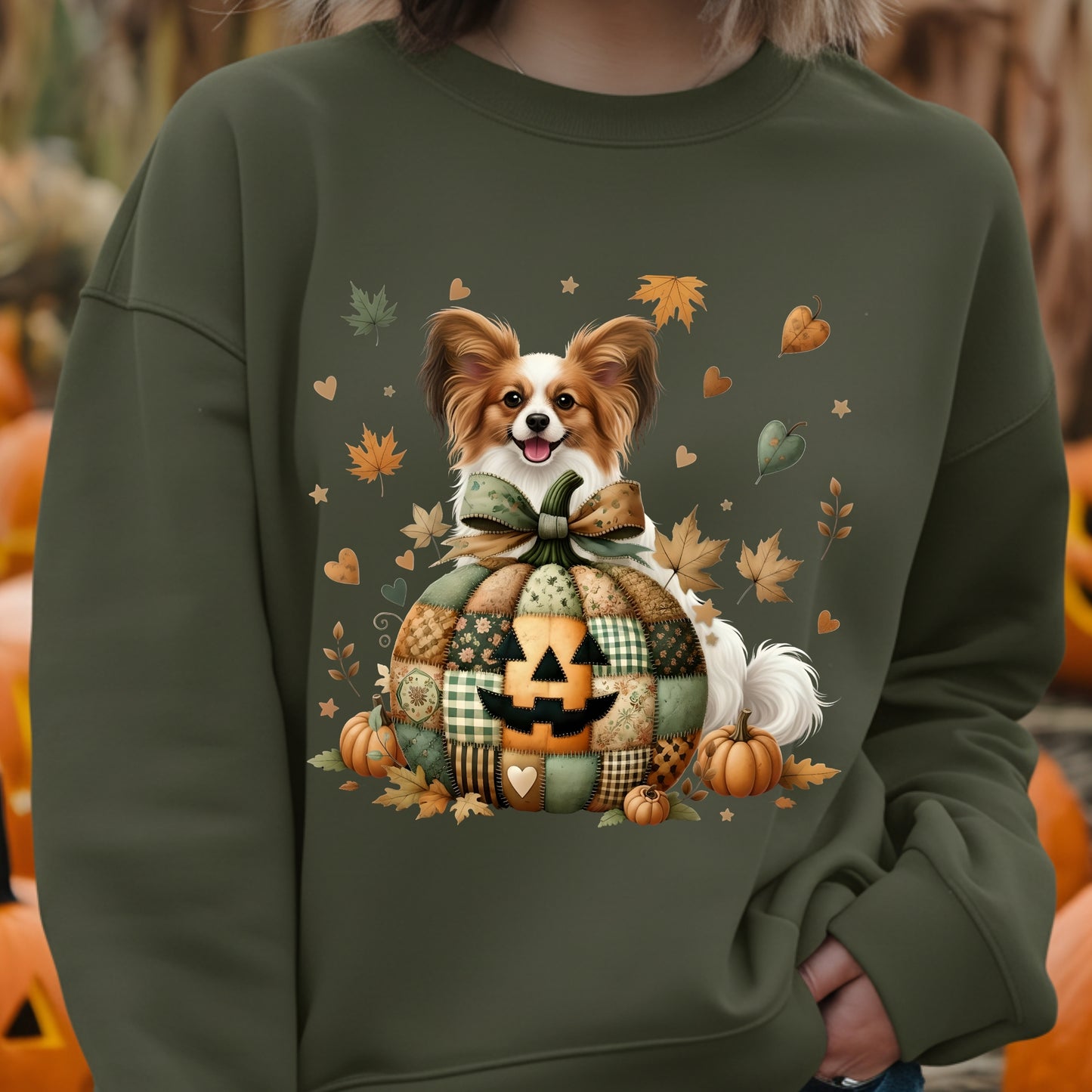 Green sweatshirt with a dog and pumpkin design, worn by a person.