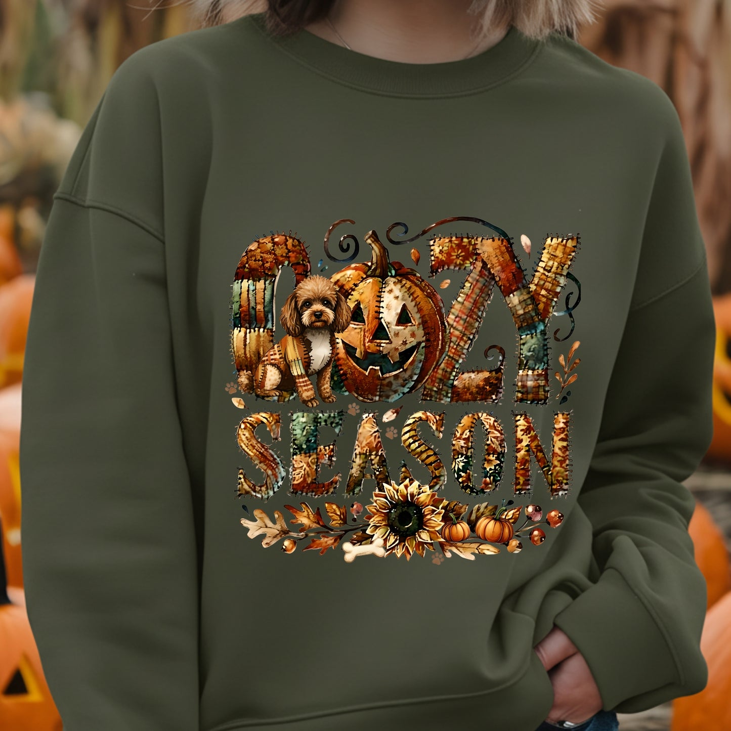 Person wearing a green sweatshirt with Halloween-themed design featuring pumpkins and text.