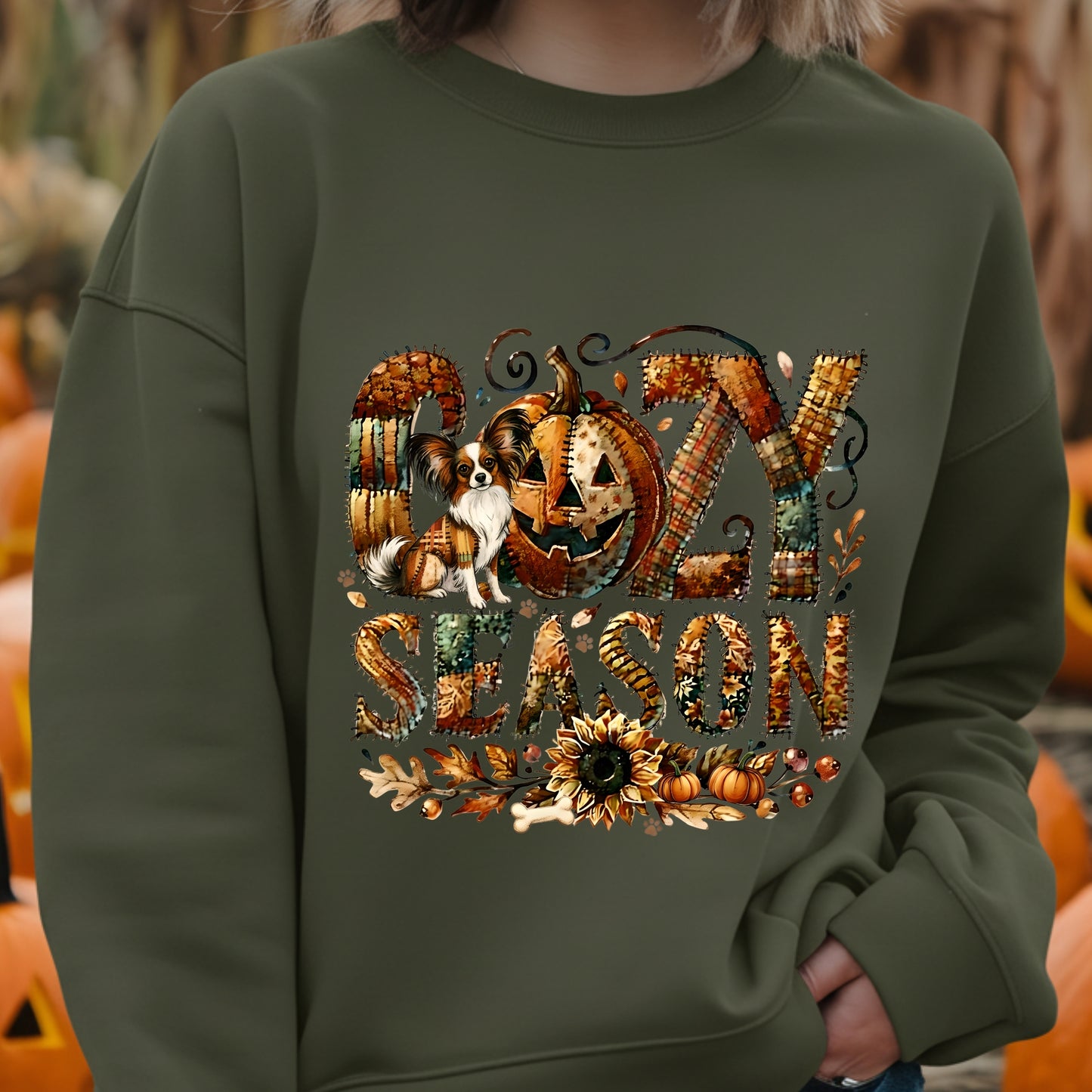 Person wearing a green sweatshirt with 'GOZY SEASON' design featuring pumpkins and a dog.