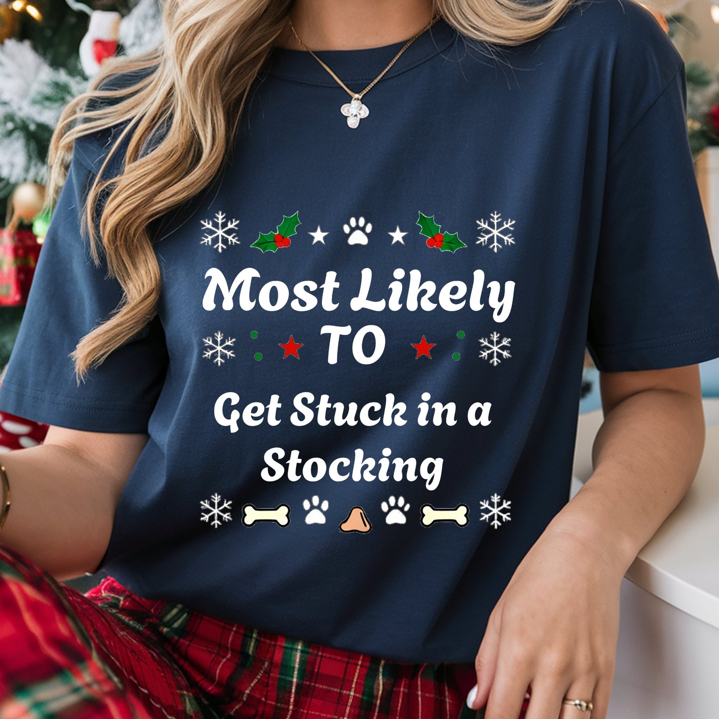 Person wearing a navy blue t-shirt with Christmas-themed text and graphics.