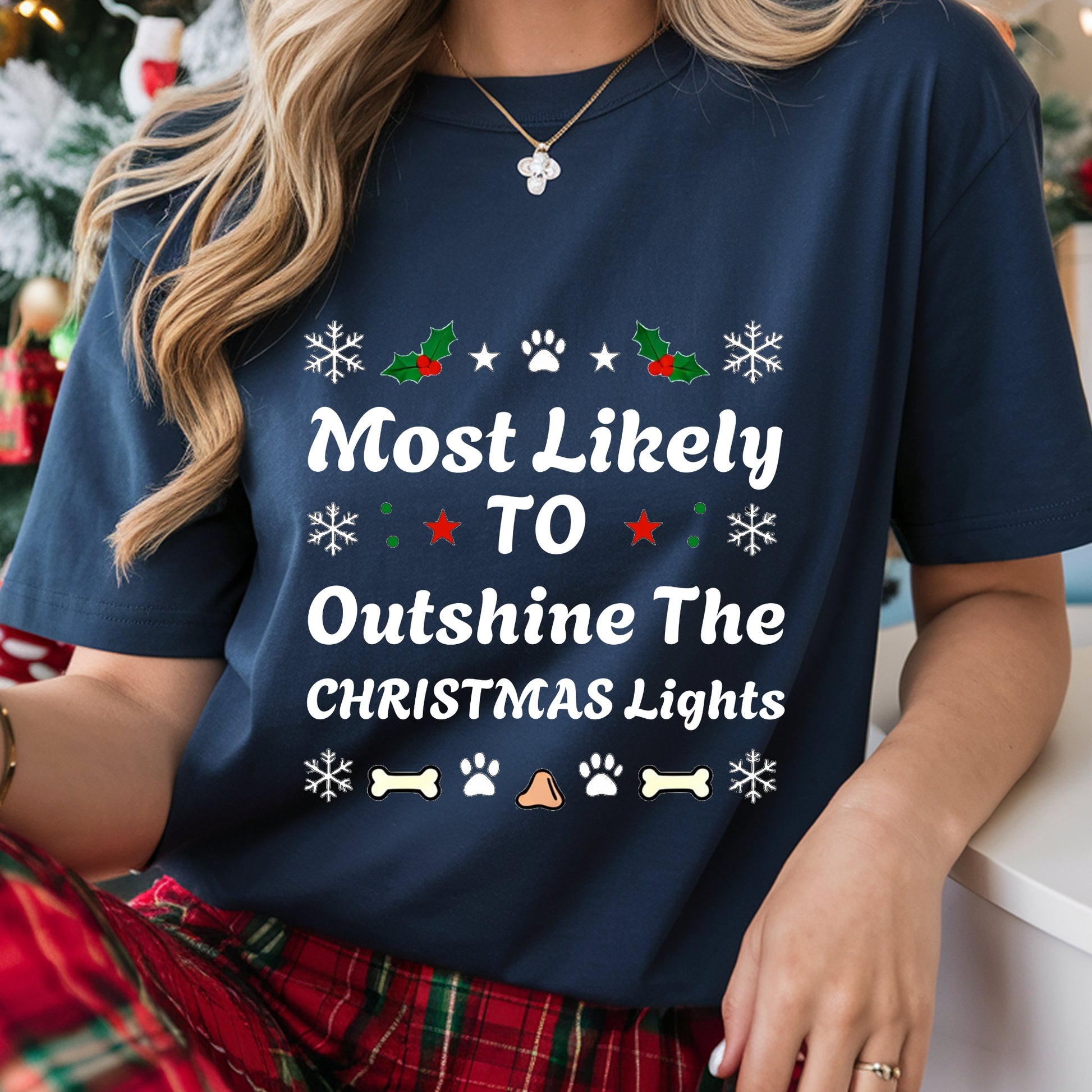 Person wearing a navy blue t-shirt with Christmas-themed text and graphics.