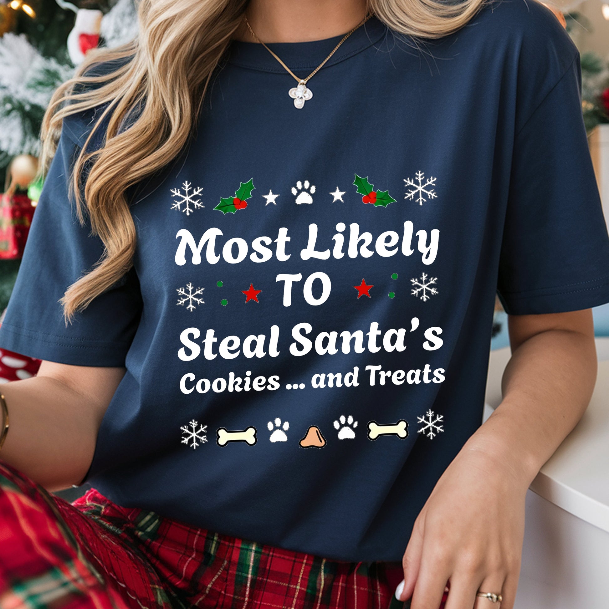 Person wearing a navy blue t-shirt with Christmas-themed text and graphics.