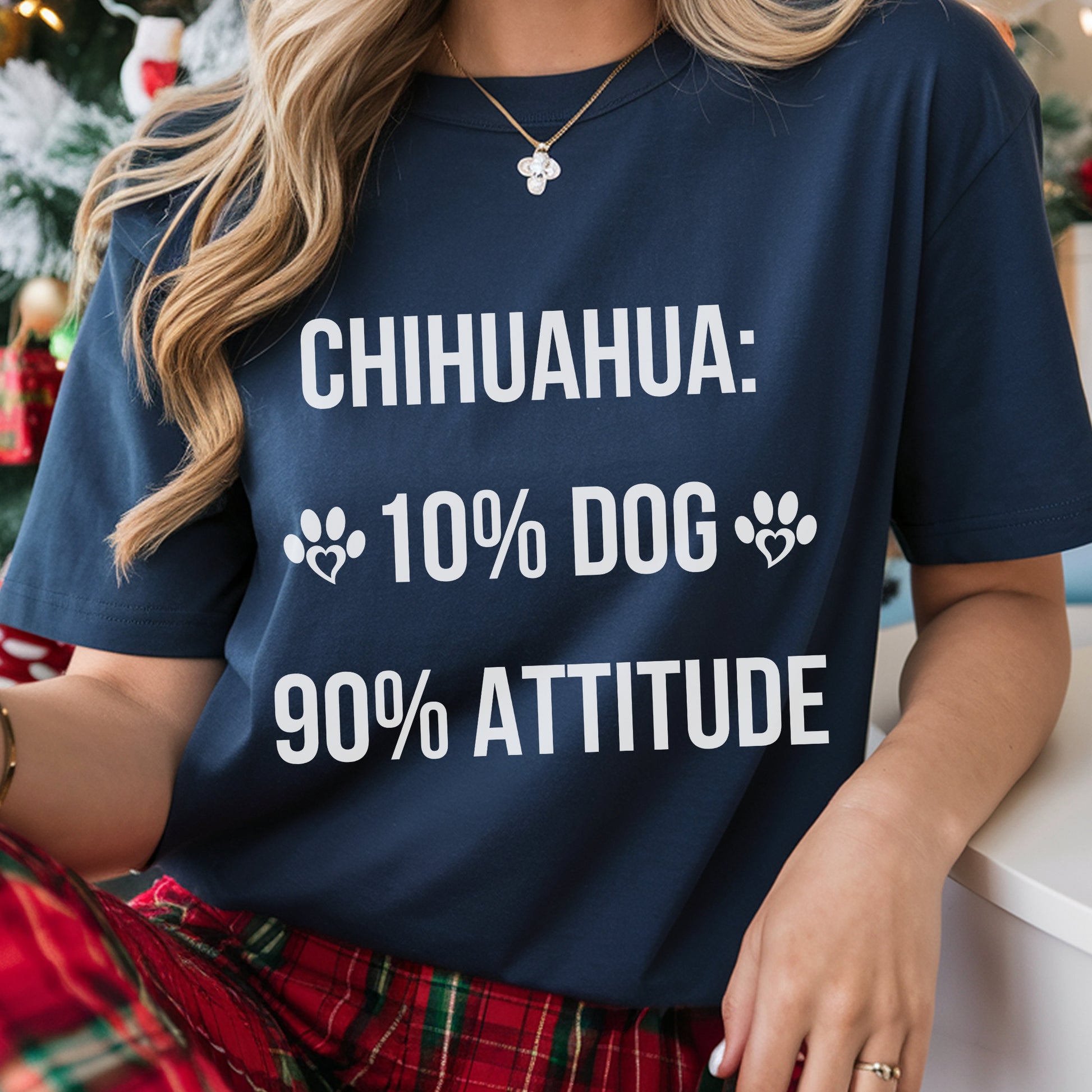 Person wearing a navy blue t-shirt with humorous text about Chihuahuas.