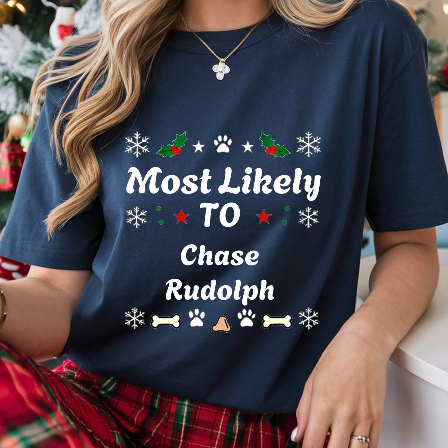 Navy blue t-shirt with Christmas-themed text and graphics worn by a person.