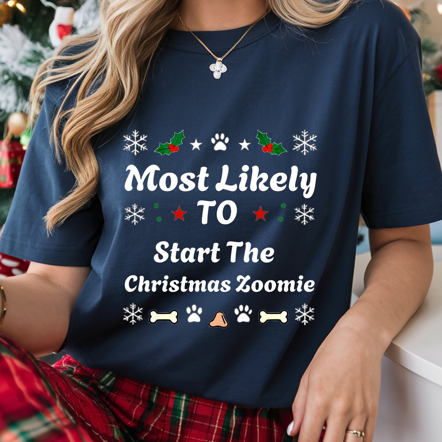Person wearing a navy blue t-shirt with Christmas-themed text and graphics.
