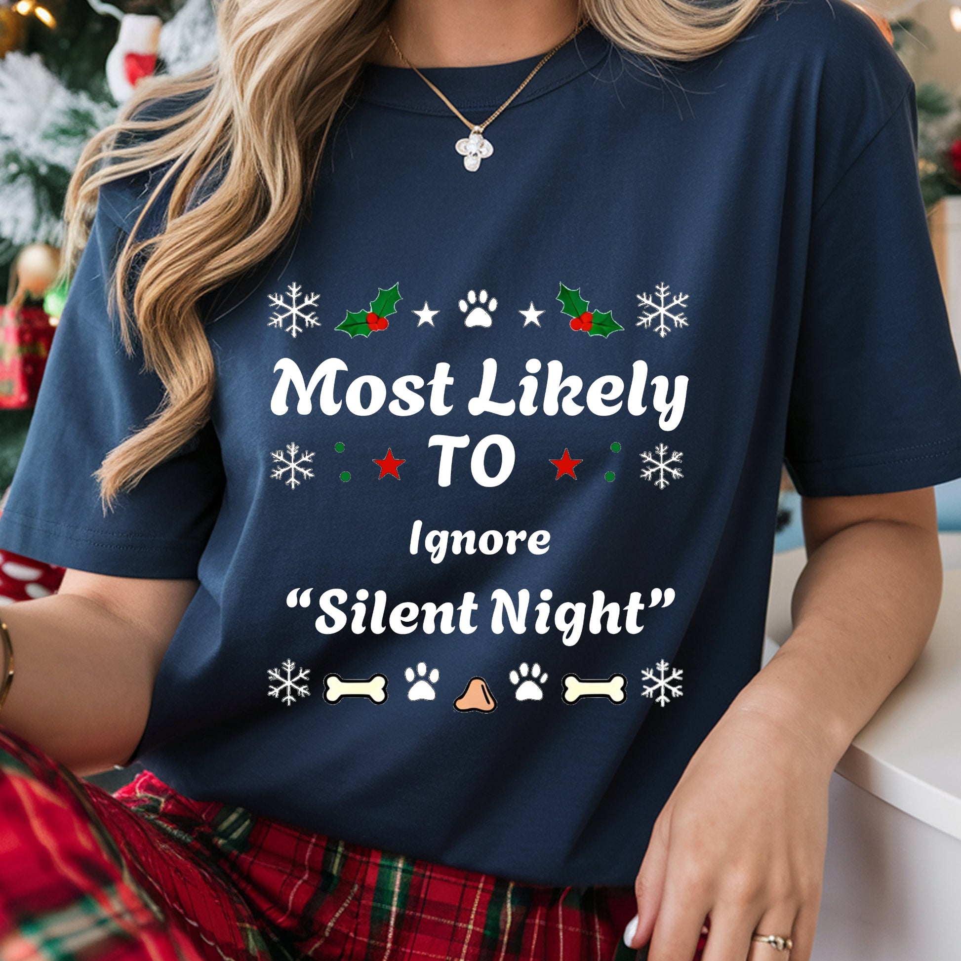 Person wearing a navy blue t-shirt with Christmas-themed text and graphics.