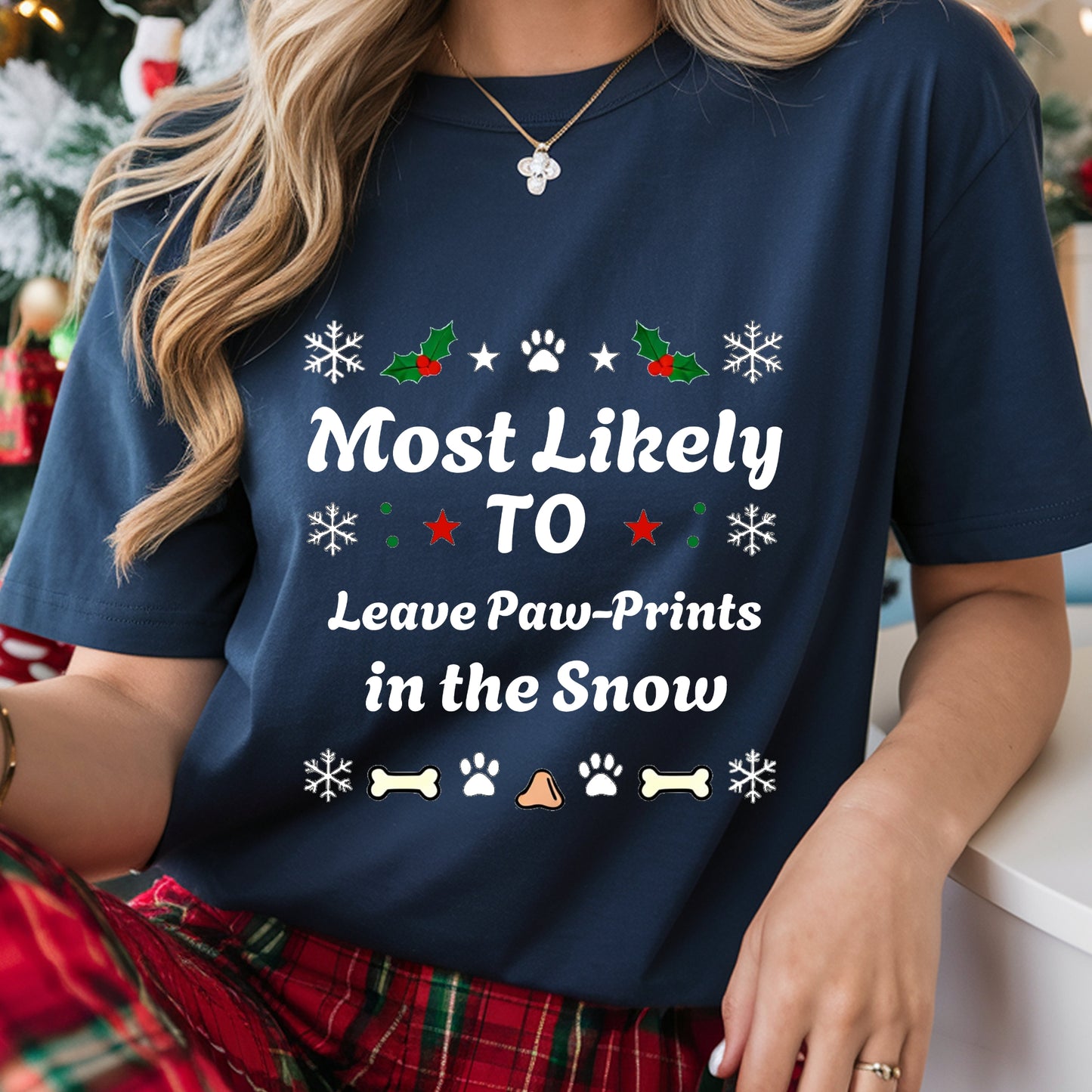 Person wearing a navy blue t-shirt with Christmas-themed text and graphics.