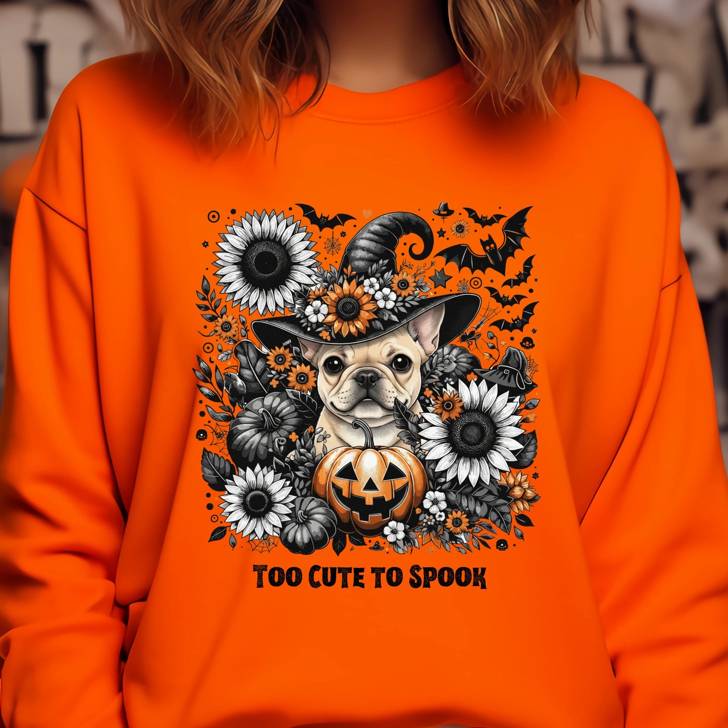 Orange sweatshirt with Halloween-themed design featuring a dog, pumpkin, and flowers.