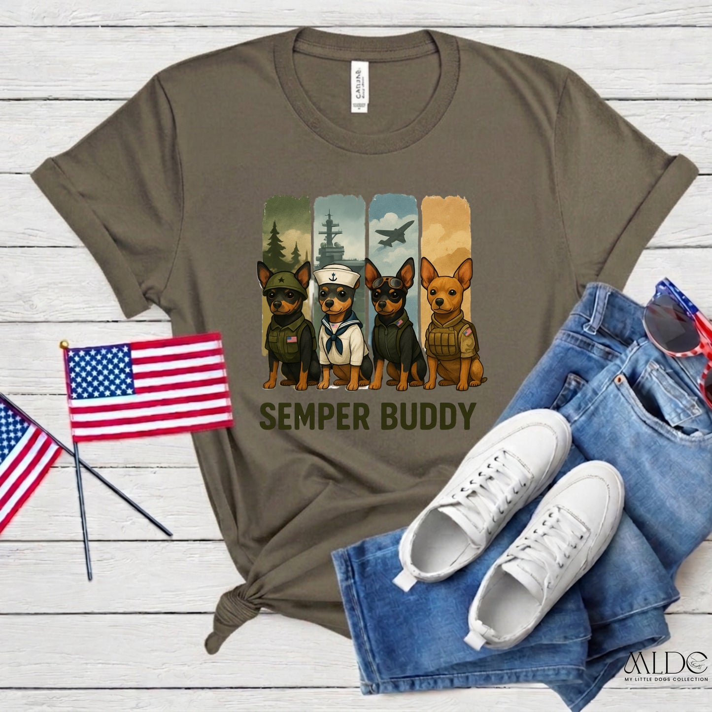 T-shirt with military-themed dog graphics and 'Semper Buddy' text, paired with jeans and sneakers on a wooden surface.