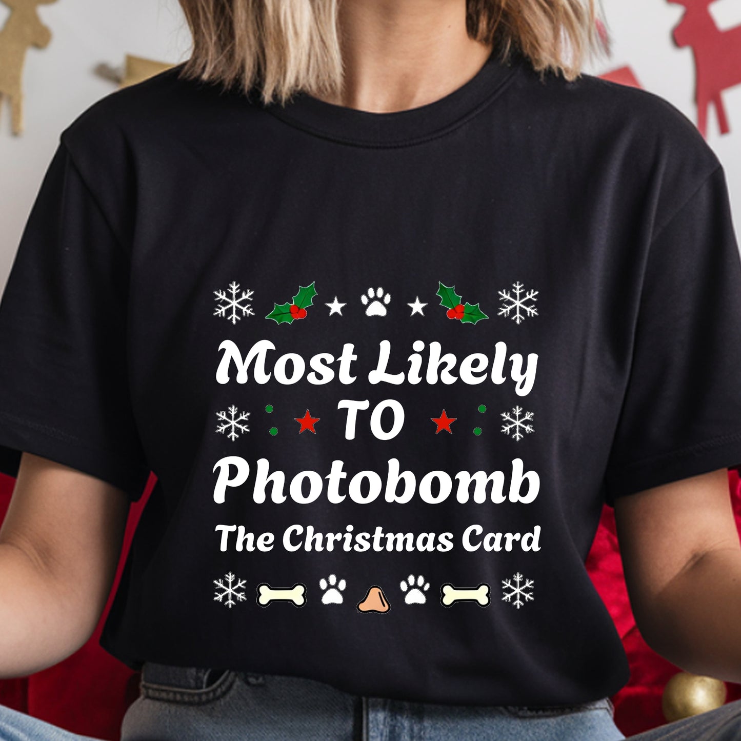 Black t-shirt with Christmas-themed text and graphics worn by a person.