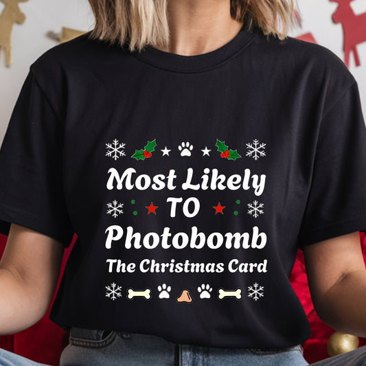 Black t-shirt with Christmas-themed text and graphics worn by a person.