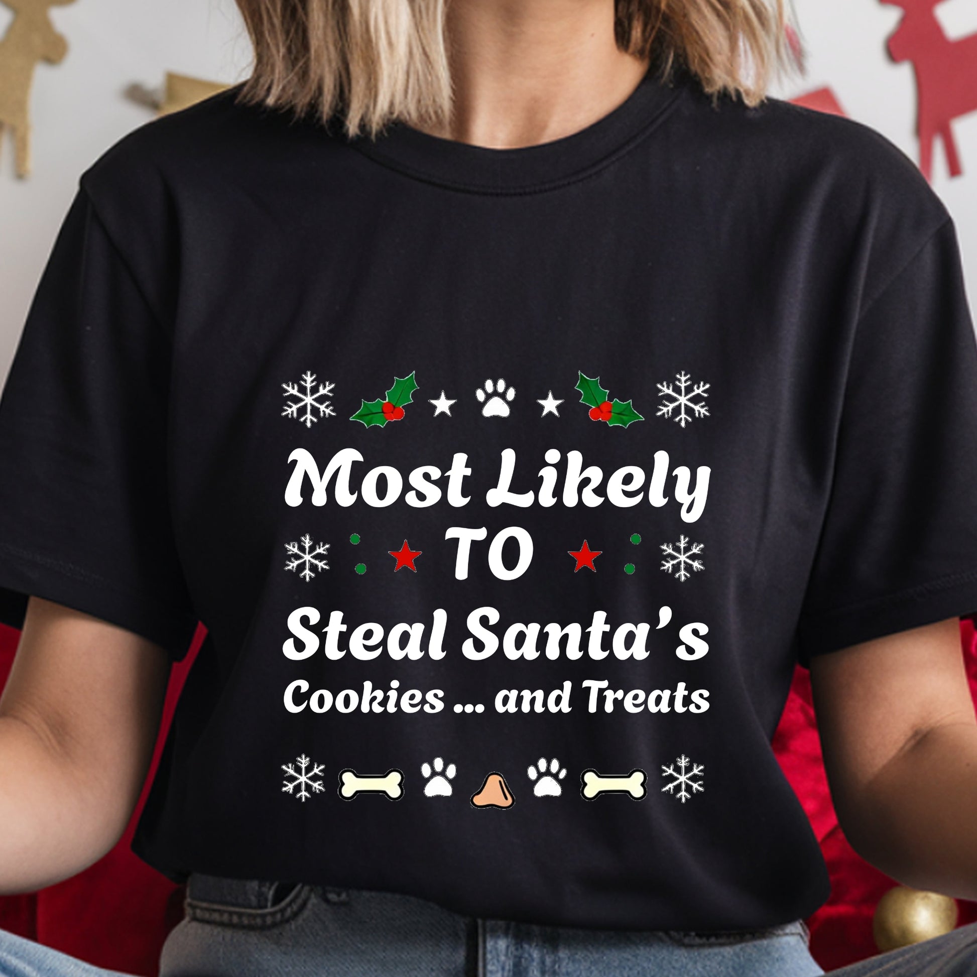 Black t-shirt with Christmas-themed text and graphics worn by a person.
