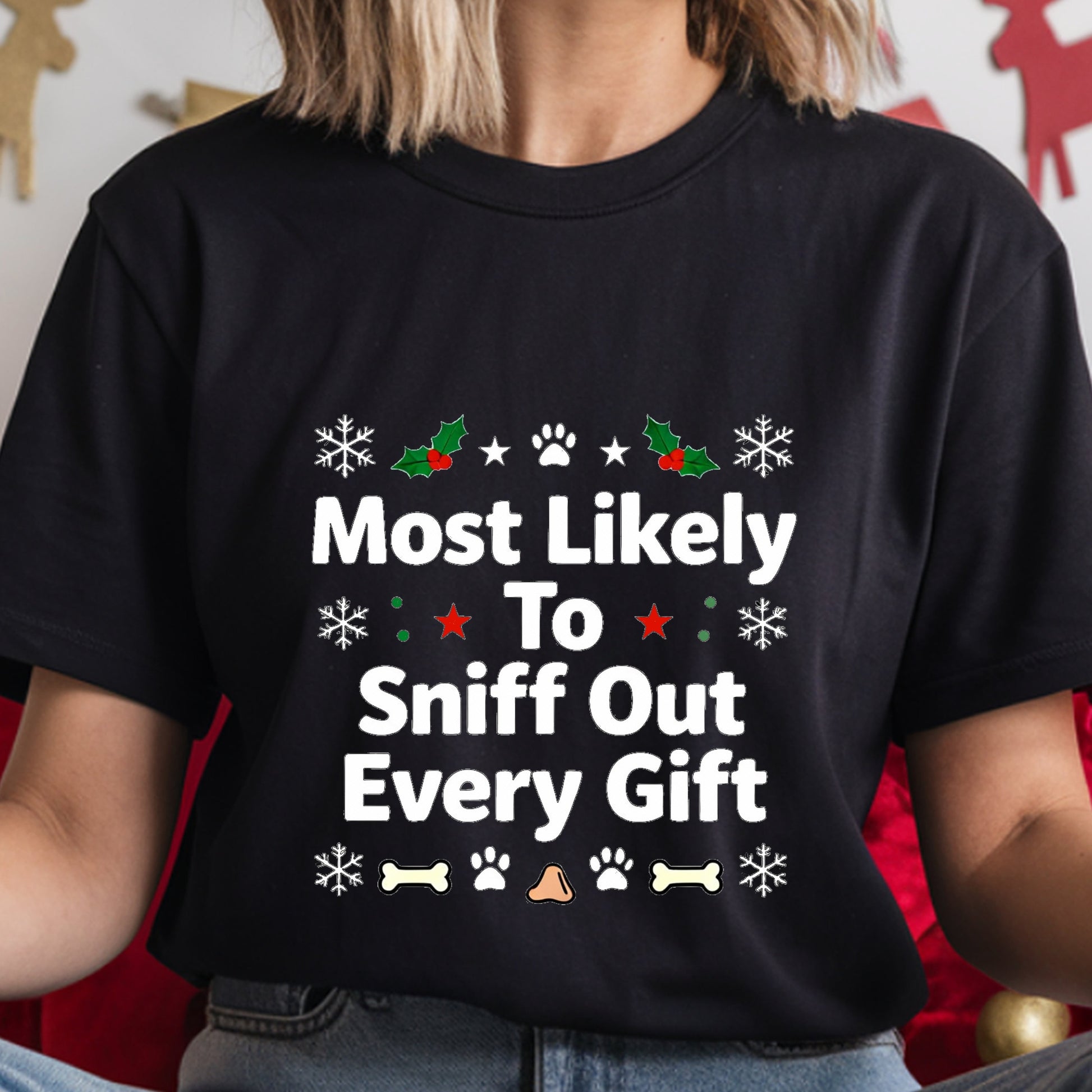 Black t-shirt with Christmas-themed text and graphics worn by a person.