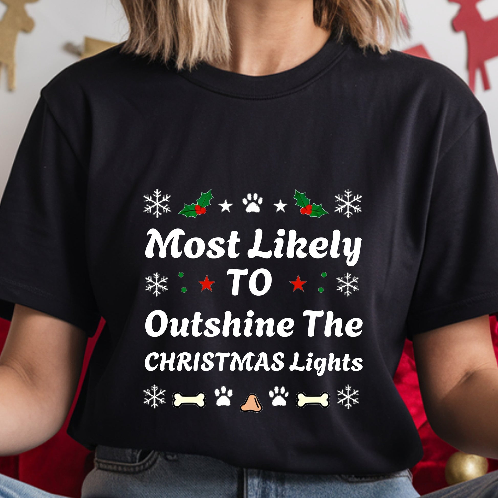 Black t-shirt with Christmas-themed text and graphics worn by a person.