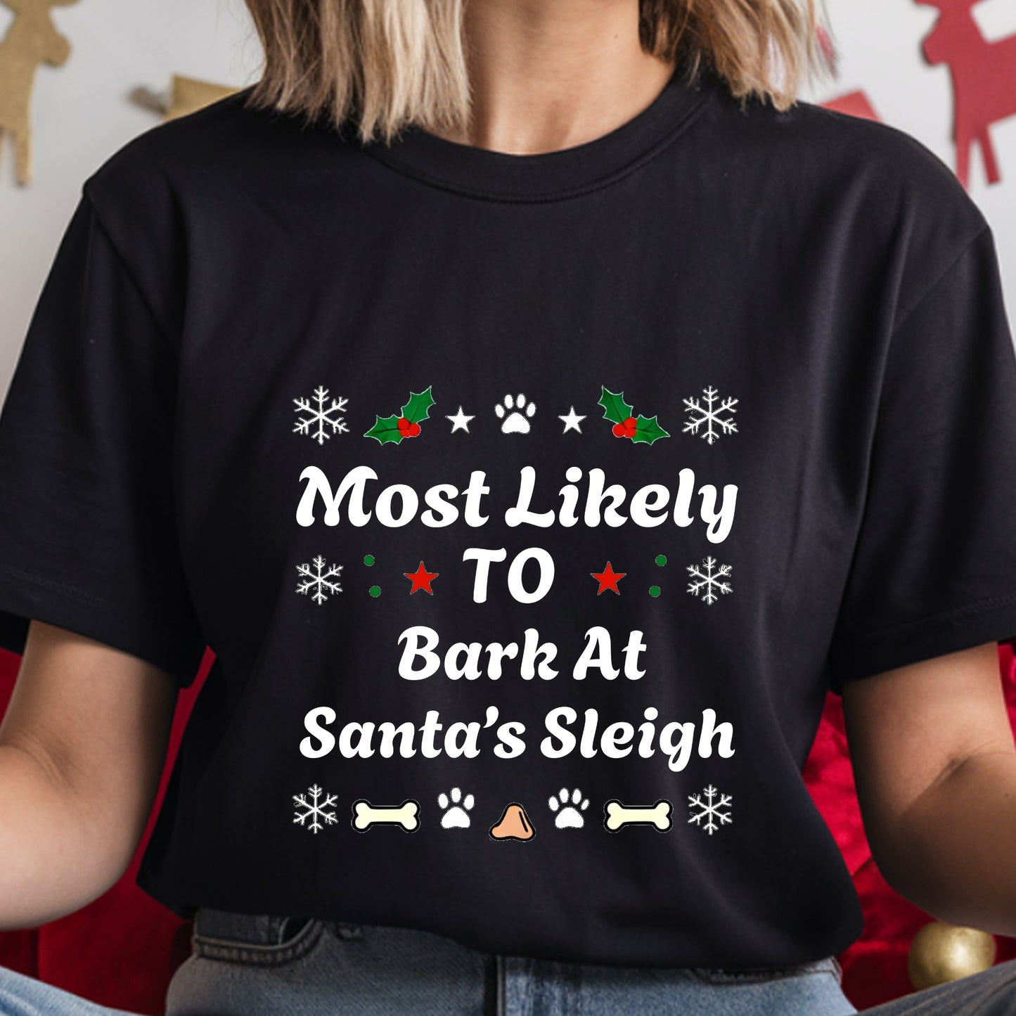 Black t-shirt with Christmas-themed text and graphics worn by a person.