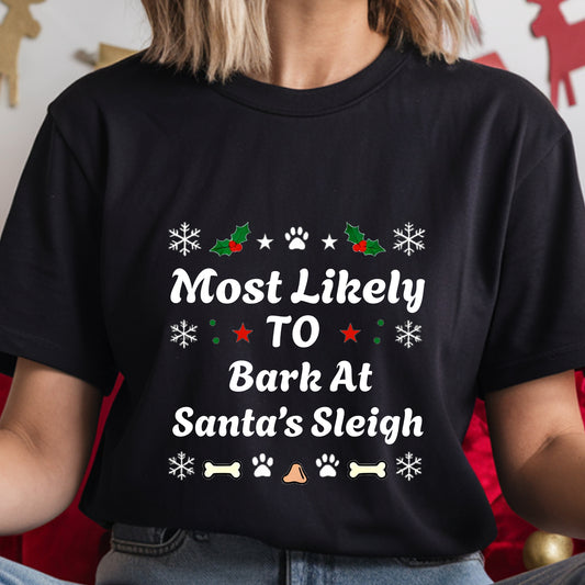 Black t-shirt with Christmas-themed text and graphics worn by a person.