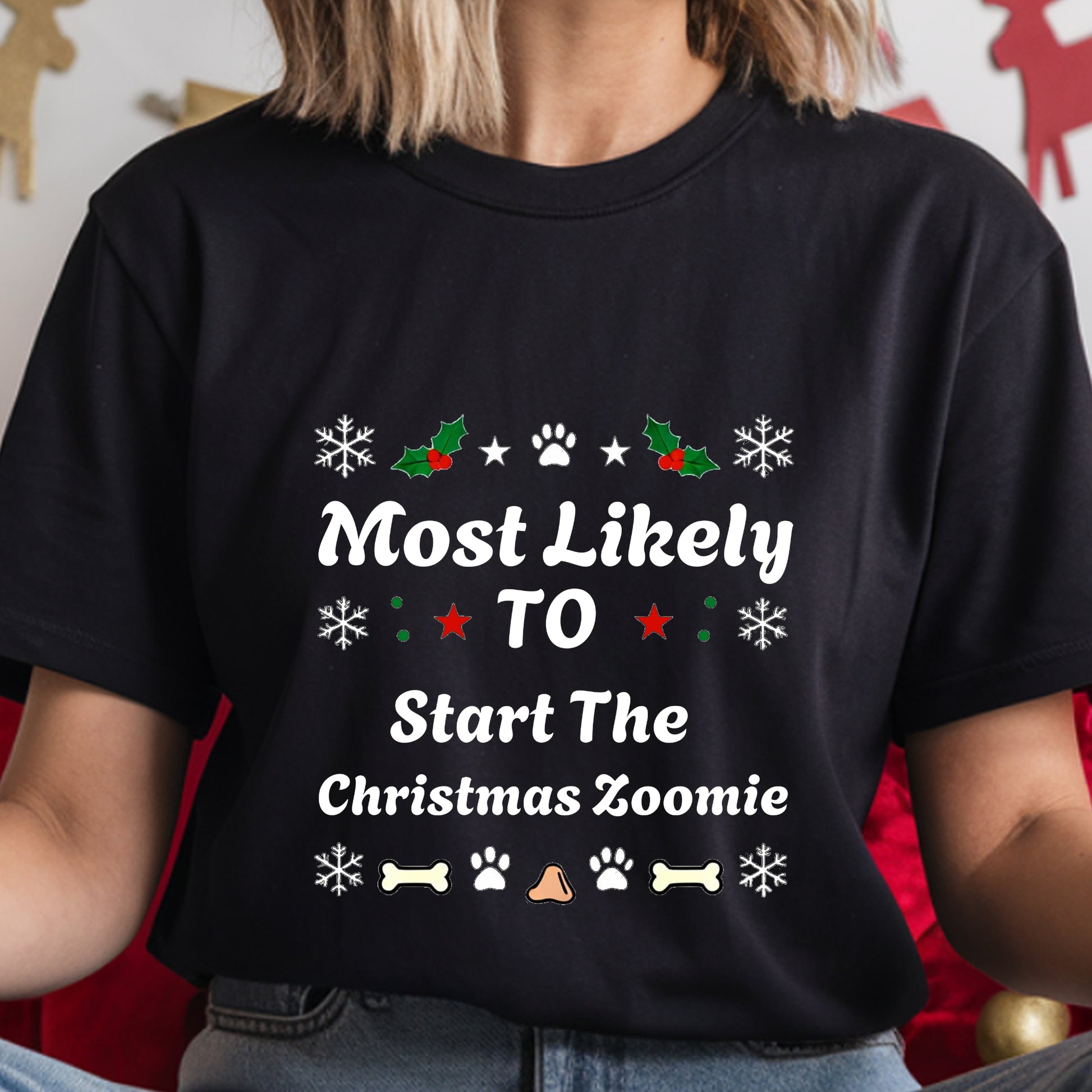 Black t-shirt with Christmas-themed text and graphics worn by a person.