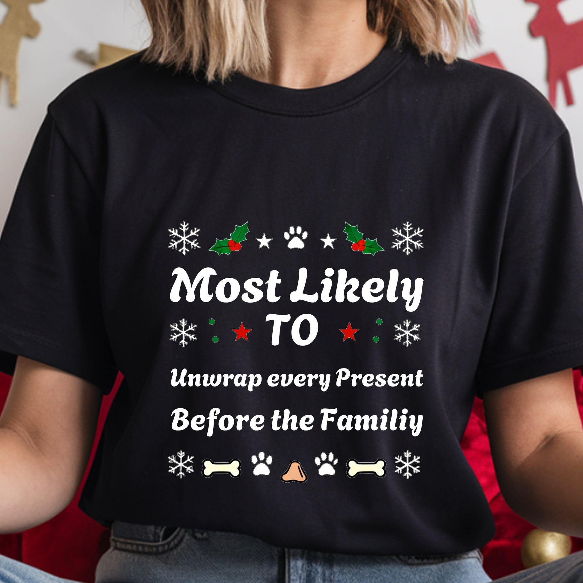Black t-shirt with Christmas-themed text and graphics worn by a person.