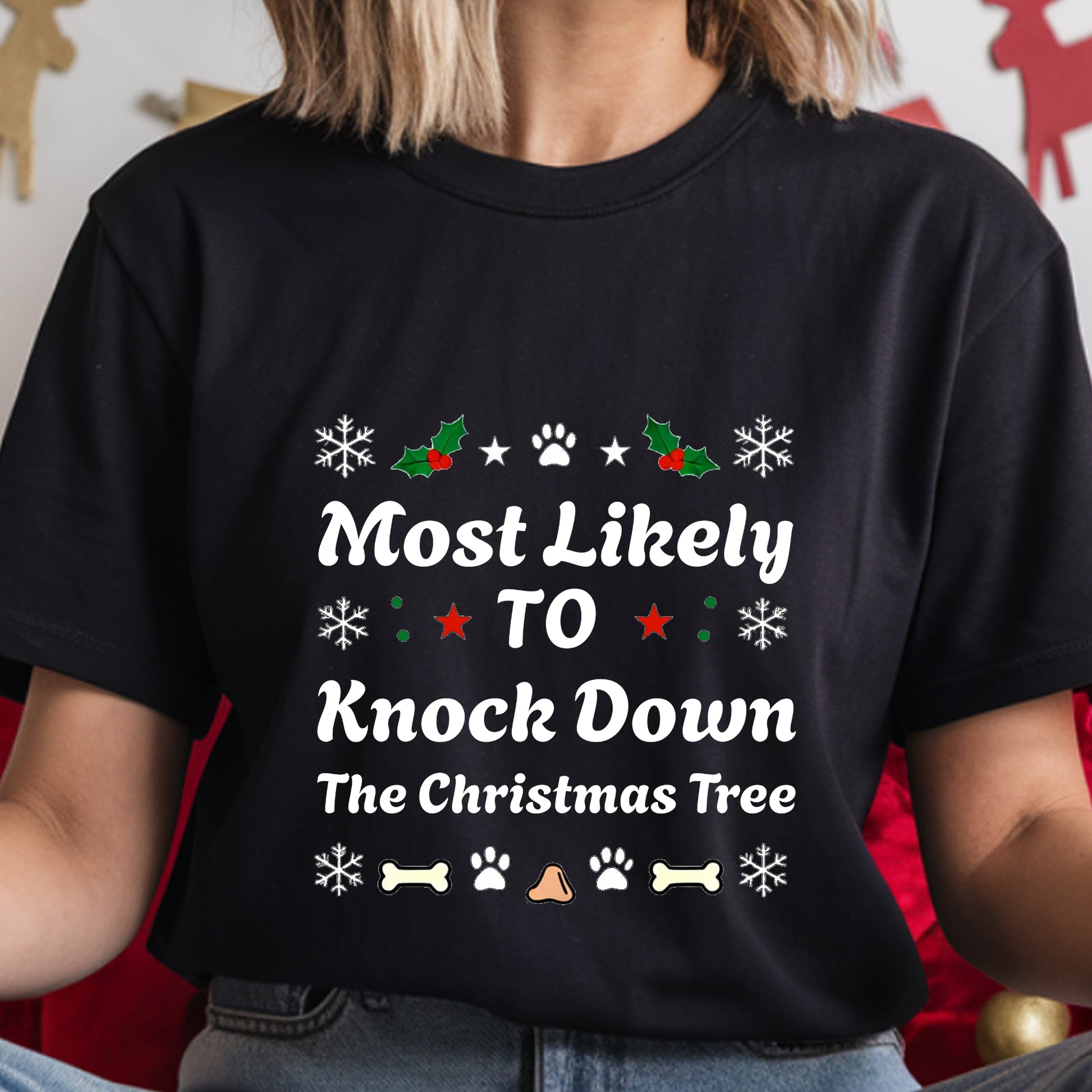 Black t-shirt with Christmas-themed text and graphics worn by a person.