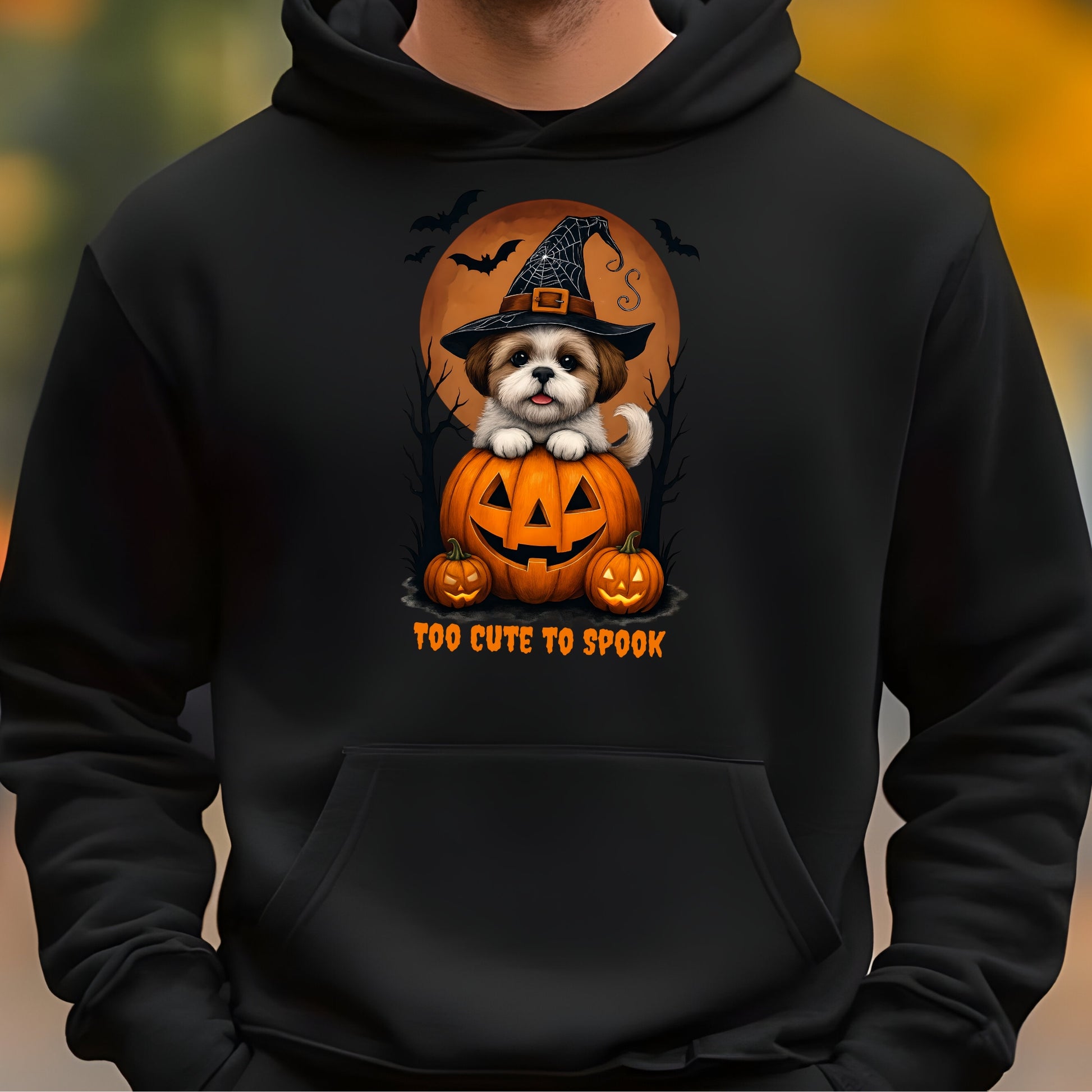 Black hoodie with a Halloween-themed design featuring a dog in a pumpkin and 'Too Cute to Spook' text.