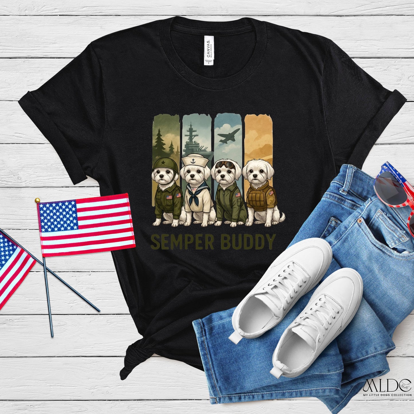 Black t-shirt with 'Semper Buddy' graphic, American flags, white sneakers, and blue jeans on a wooden surface.