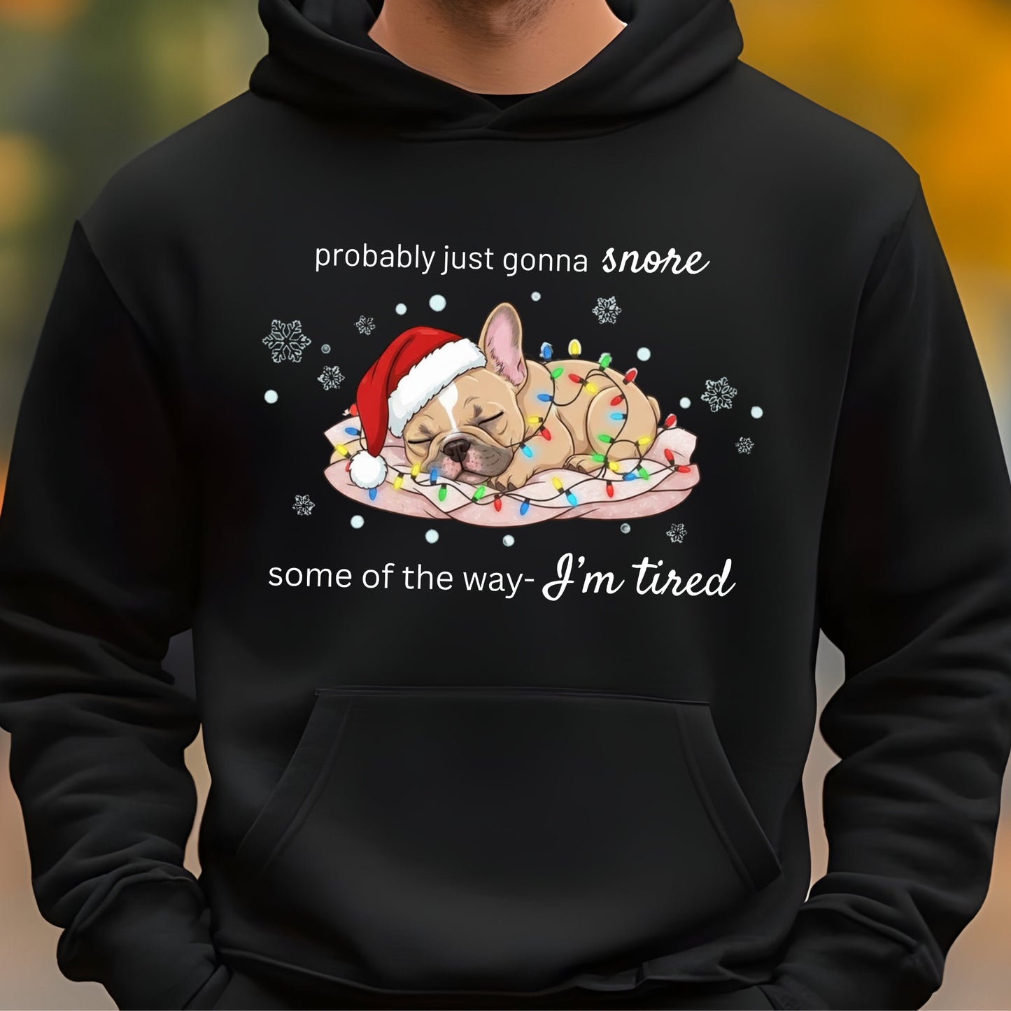 Black hoodie with a Christmas-themed design of a dog and text on a blurred background
