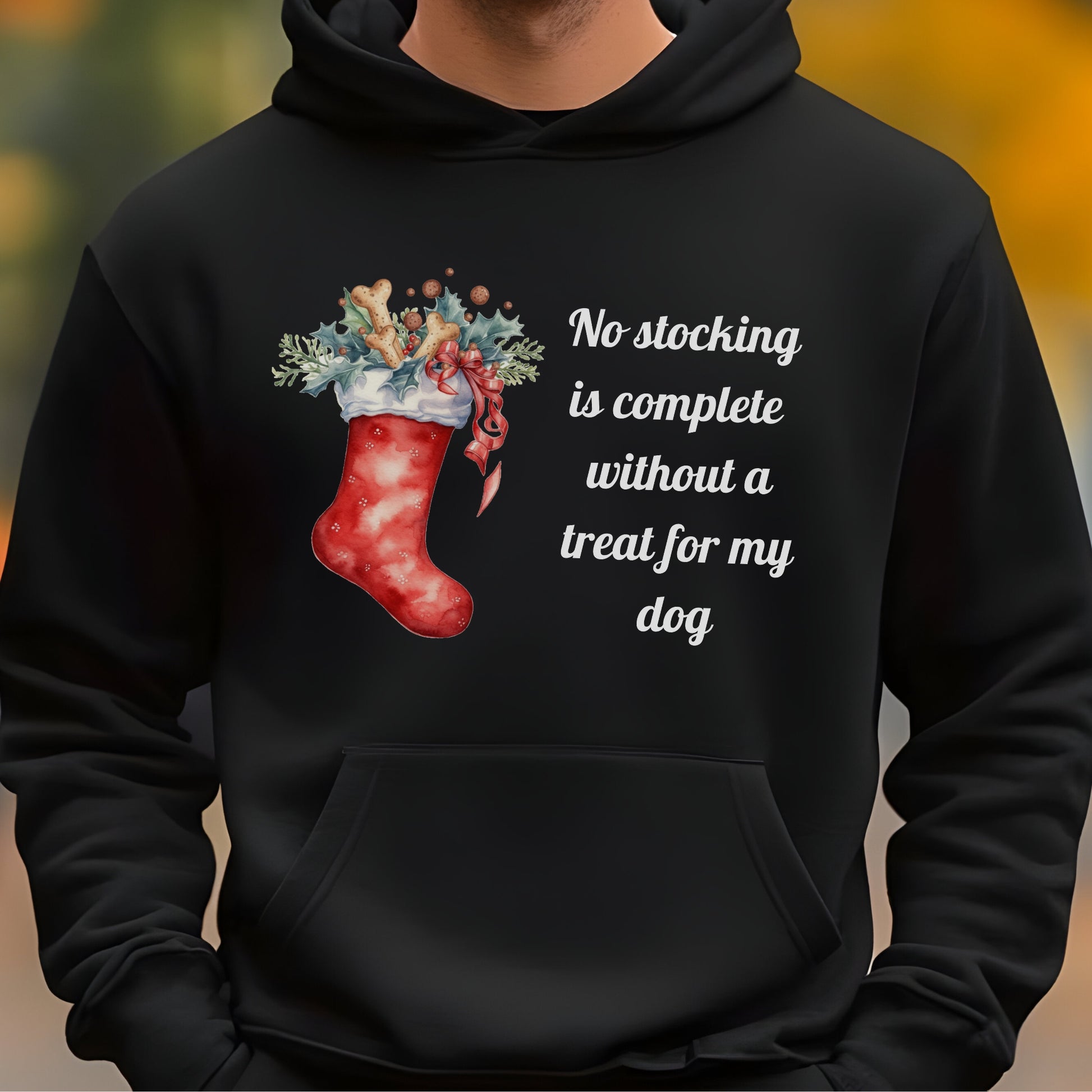 Black hoodie with a Christmas stocking design and text on a blurred background