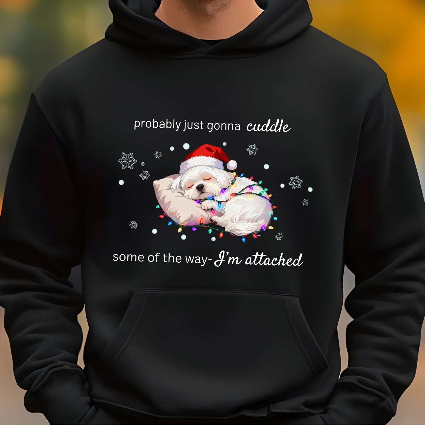 Black hoodie with a Christmas-themed design of two dogs in Santa hats and lights, text 'probably just gonna cuddle some of the way I'm attached'.