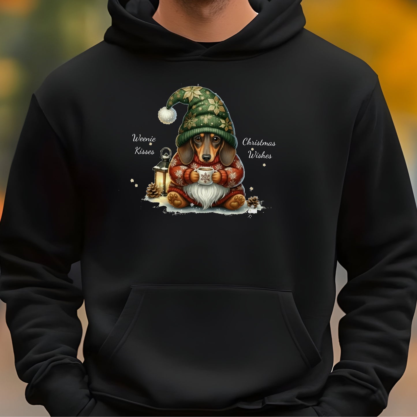 Black hoodie with a Christmas-themed design featuring a dog wearing a green elf hat and holding a mug.