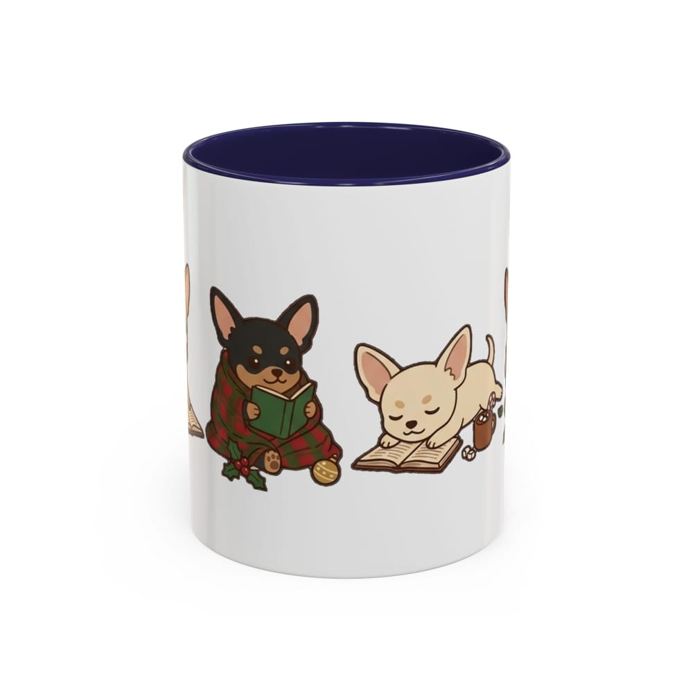 White ceramic mug with a navy interior, showing a black-and-tan Chihuahua in a plaid blanket reading a green book beside a cream Chihuahua napping on an open book.