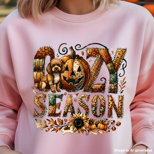 Pink sweatshirt with Halloween-themed design featuring pumpkins and text on a blurred background