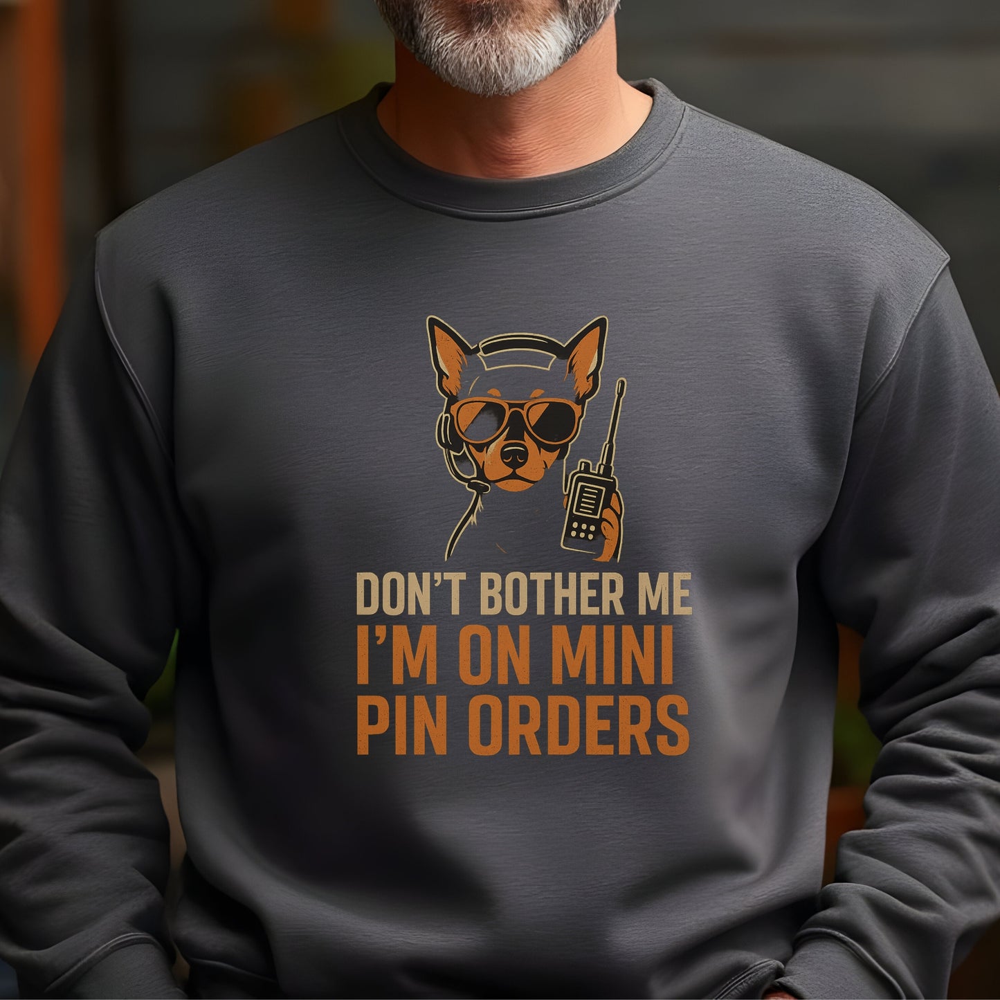 Dark heather unisex sweatshirt with a Miniature Pinscher in headset and sunglasses, text: "DON’T BOTHER ME I’M ON MINI PIN ORDERS"