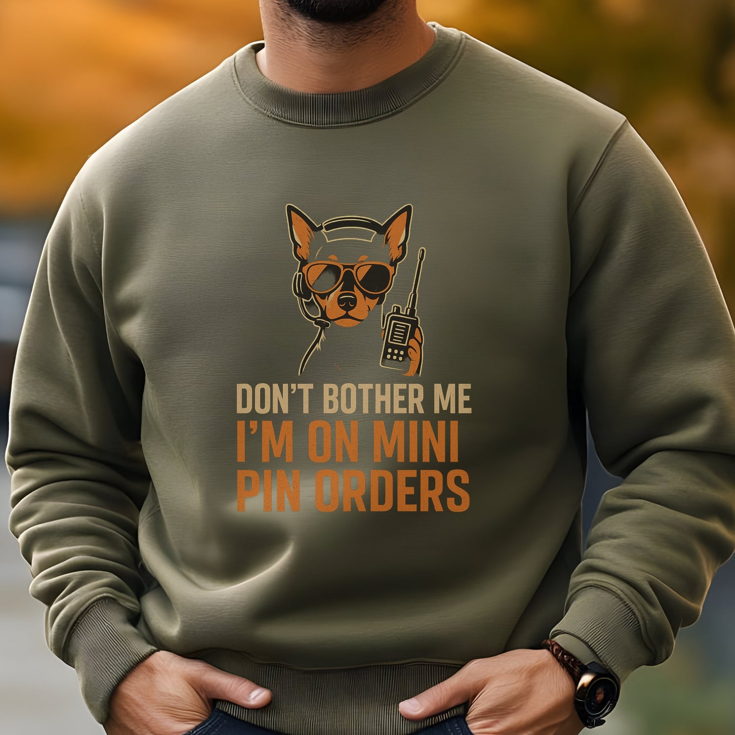 Military Green unisex sweatshirt with a Miniature Pinscher in headset and sunglasses, text: "DON’T BOTHER ME I’M ON MINI PIN ORDERS"