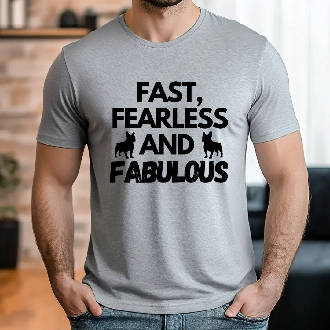 Man wearing a grey t-shirt with the slogan "Fast, Fearless and Fabulous" and French Bulldog silhouettes, outdoors on a sunny path.