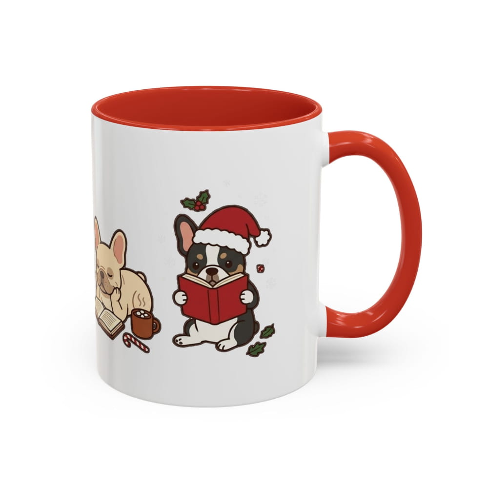 White ceramic mug with a red interior and red handle, showing a black-and-white French Bulldog in a Santa hat reading a red book, with a cream French Bulldog beside it.