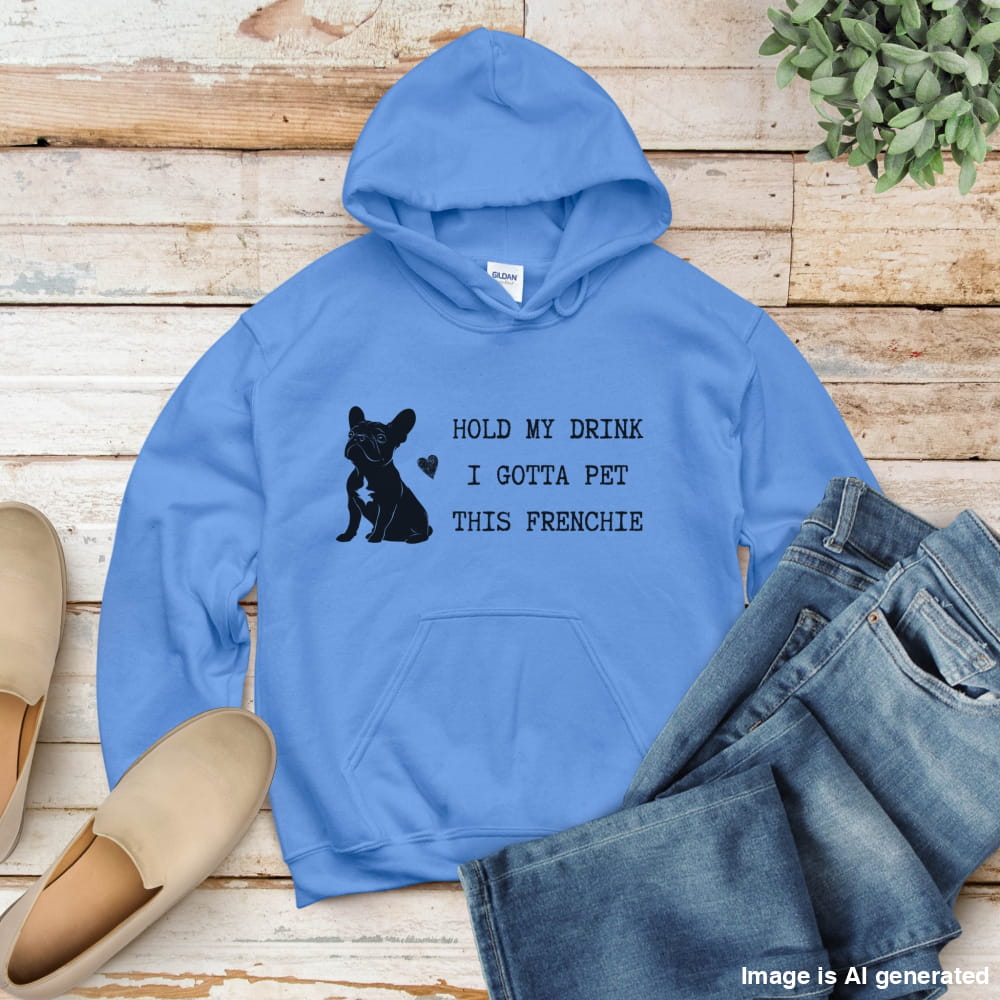 California blue flat lay hoodie with a black line-art French Bulldog illustration and the bold text “Hold my drink, I gotta pet this Frenchie” printed on the front.
