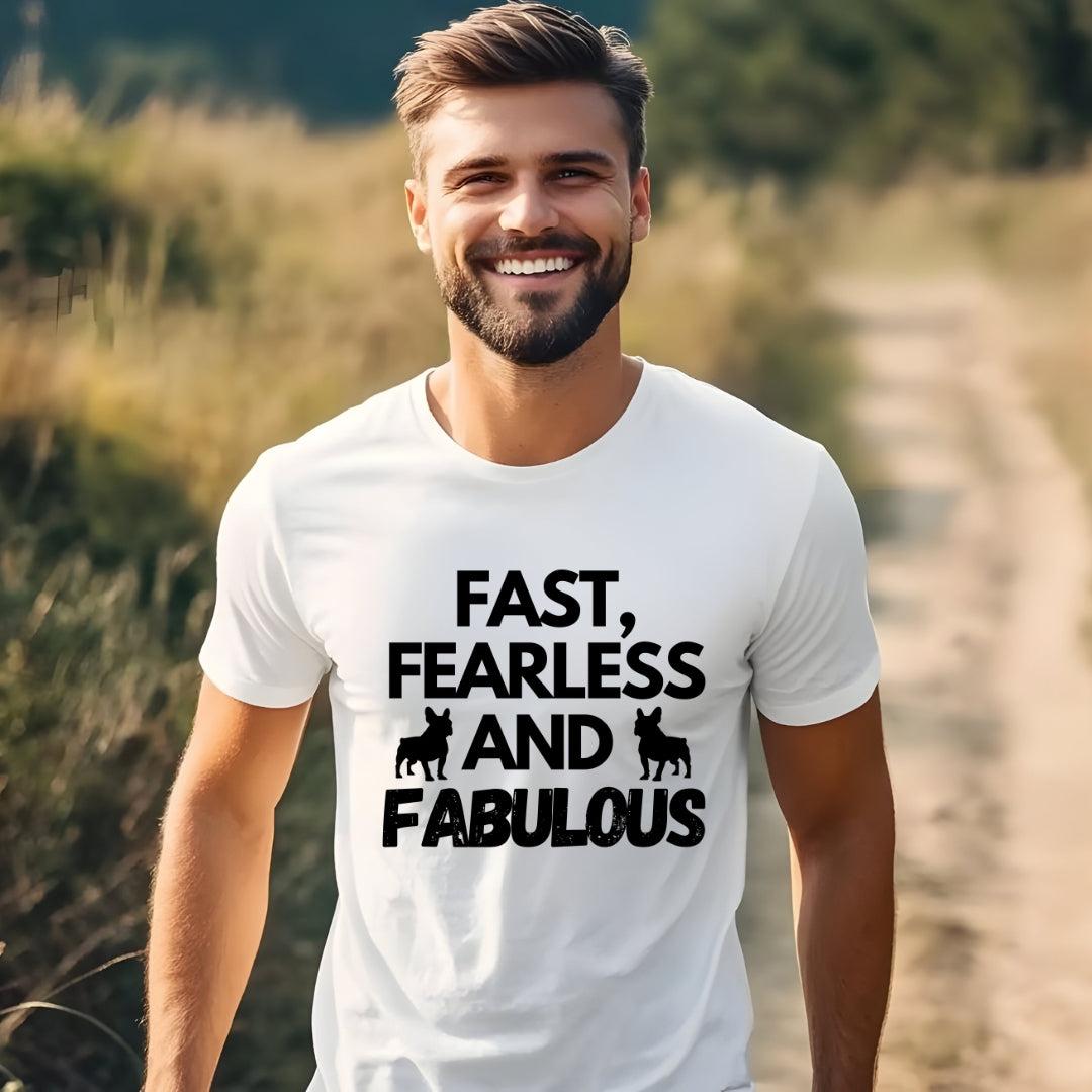 Man wearing a white t-shirt with the slogan "Fast, Fearless and Fabulous" and French Bulldog silhouettes, outdoors on a sunny path.