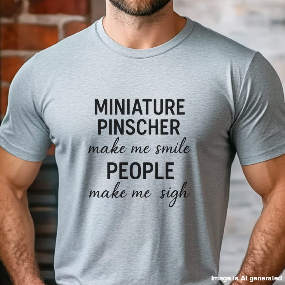 Man wearing a grey "Miniature Pinscher make me smile, people make me sigh" unisex t-shirt, casual kitchen background