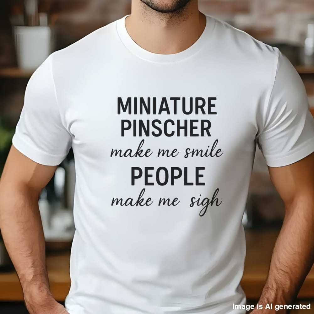 Man wearing a white "Miniature Pinscher make me smile, people make me sigh" unisex t-shirt, casual kitchen background