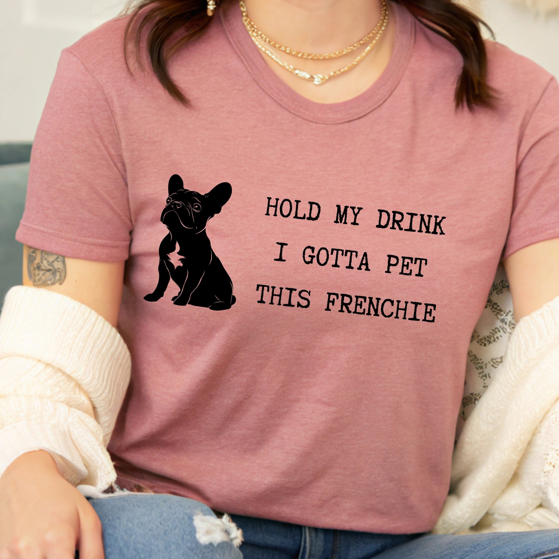 Person wearing a pink t-shirt with a dog graphic and text.