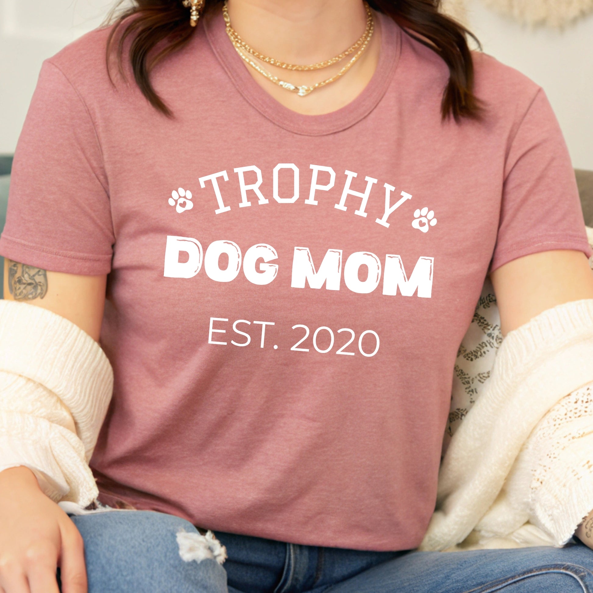 Person wearing a pink t-shirt with 'Trophy Dog Mom Est. 2020' text.