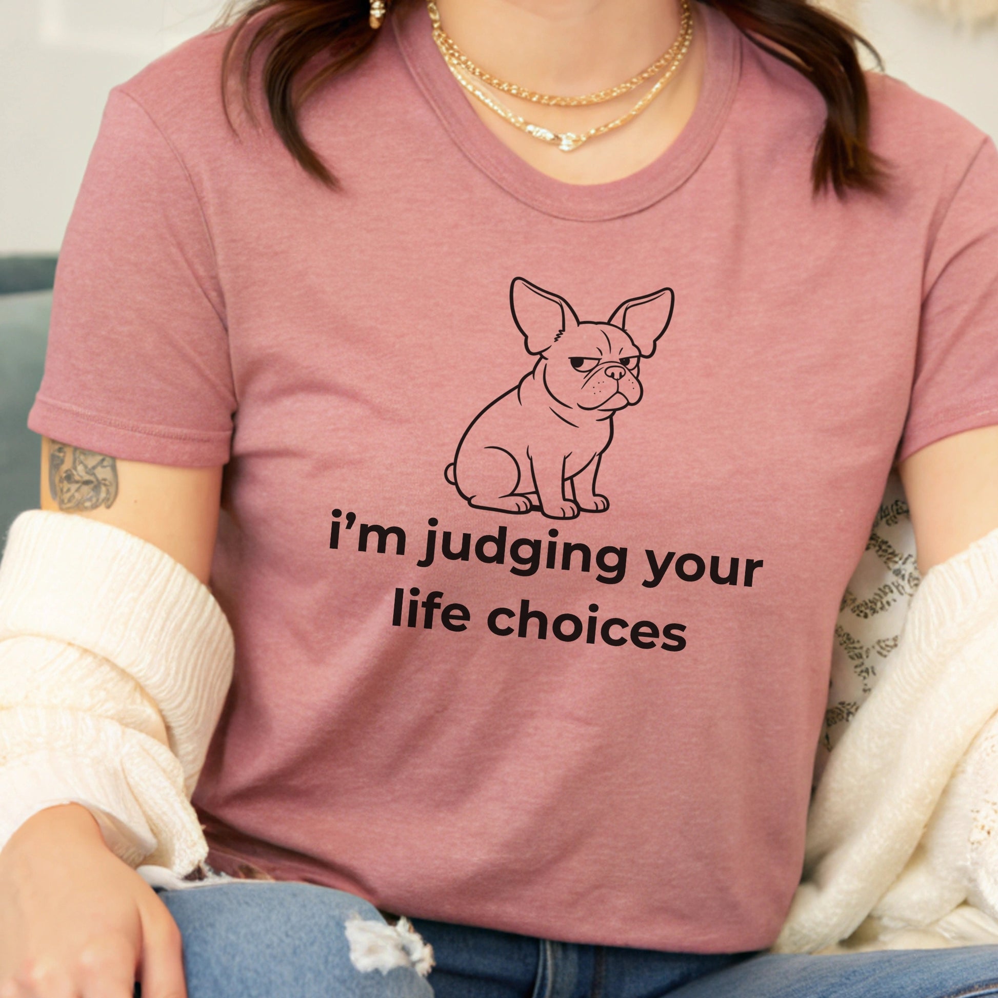 Person wearing a pink t-shirt with a dog graphic and text 'i'm judging your life choices'.