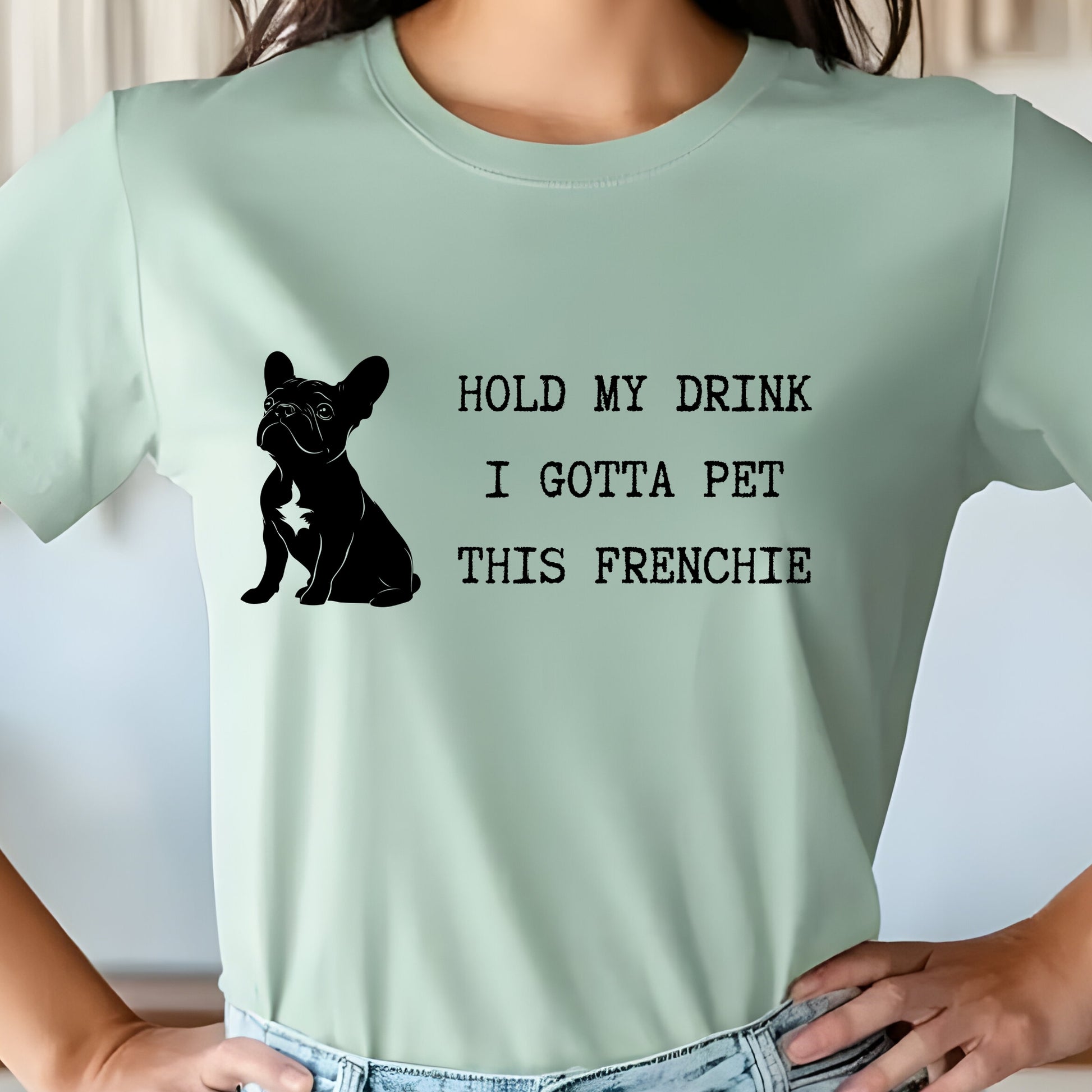 Light green t-shirt with a black dog graphic and text on a plain background