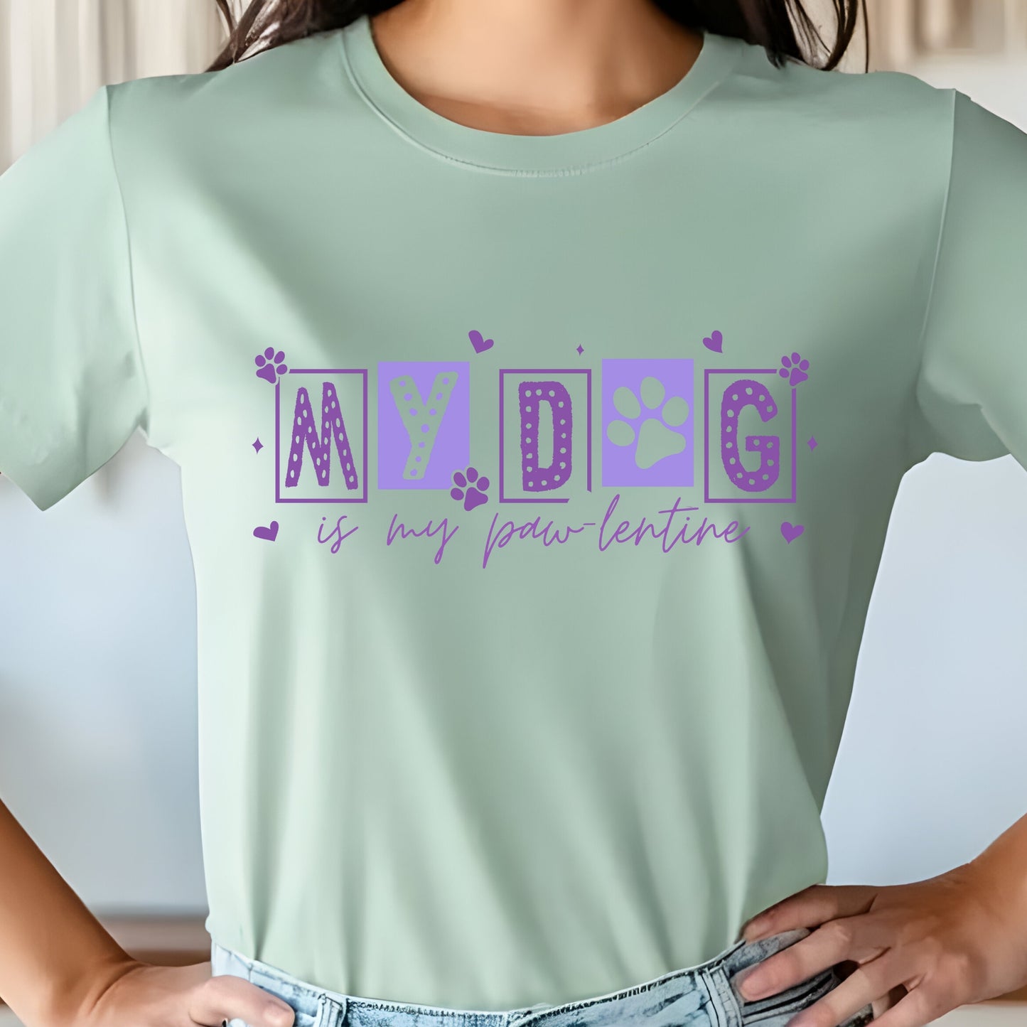 Light green t-shirt with purple text 'MY DOG is my paw-lentine' worn by a person.