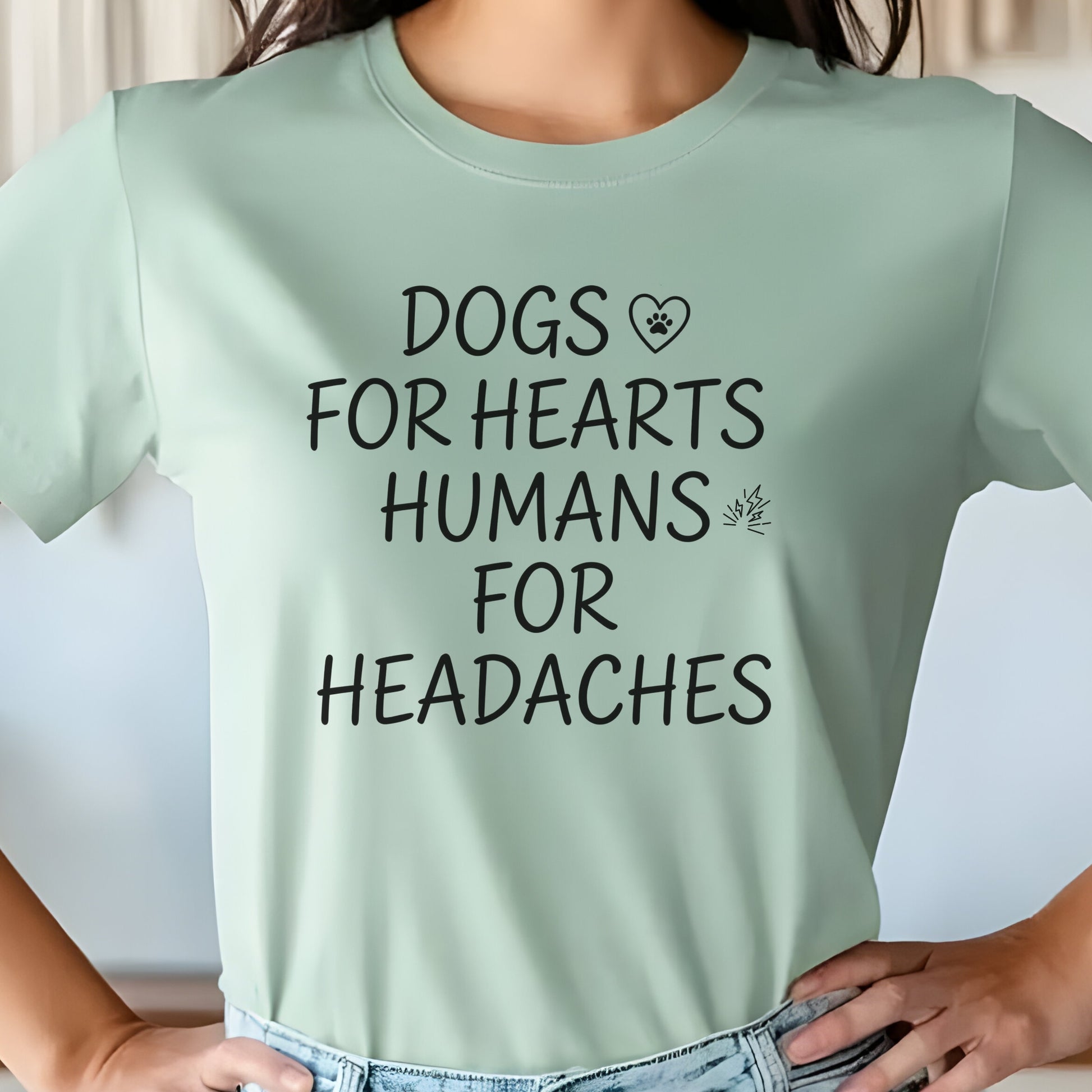 Light green t-shirt with text 'DOGS FOR HEARTS HUMANS FOR HEADACHES' worn by a person.