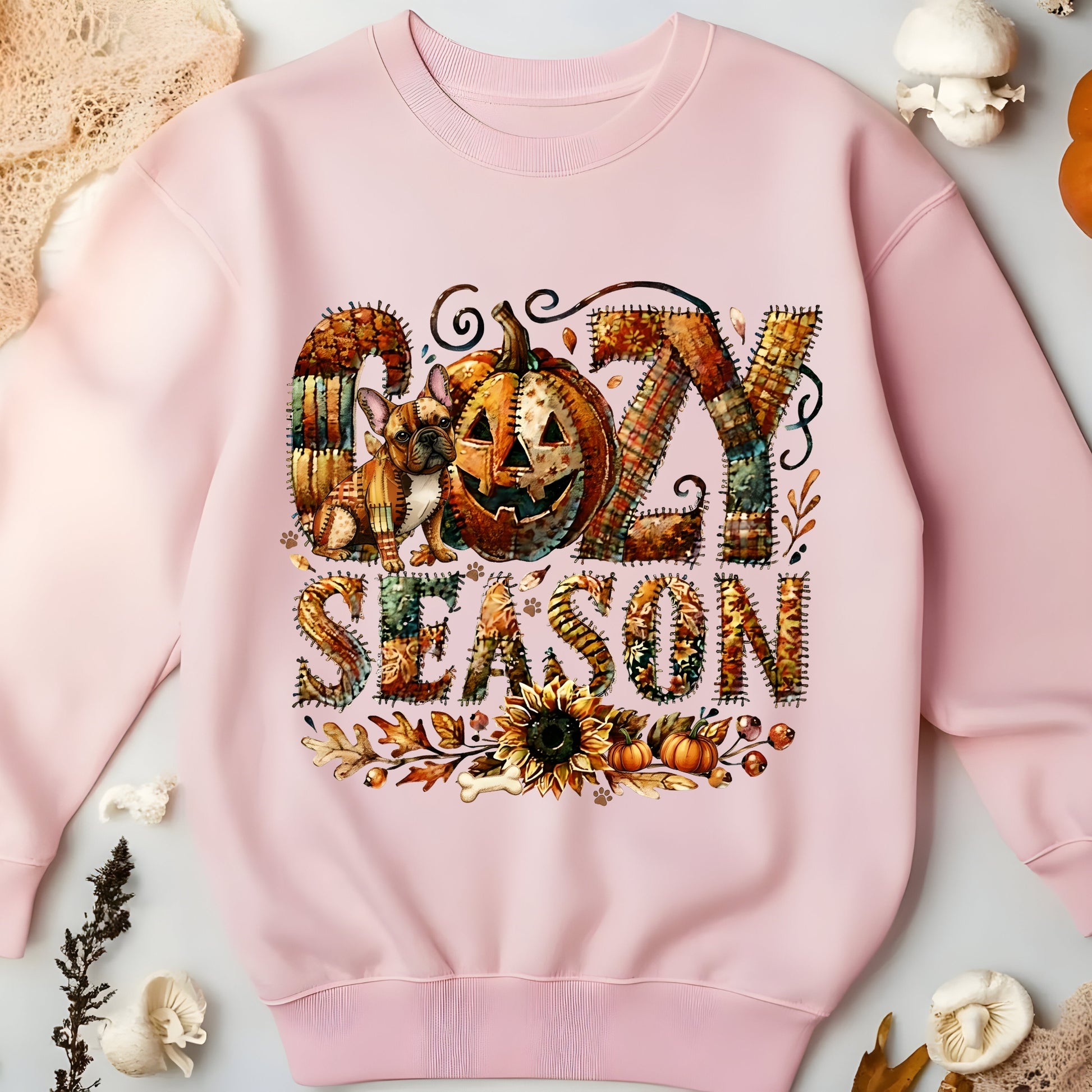 Pink sweatshirt with 'Gozy Season' design featuring a pumpkin and dog, surrounded by autumn elements.
