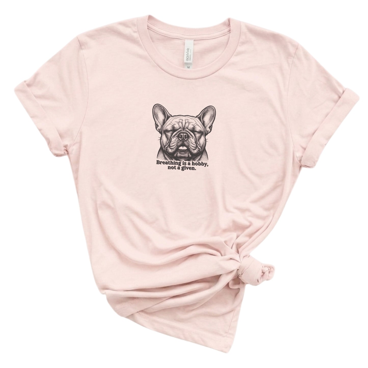 Pink t-shirt with a graphic of a dog and text on a white background